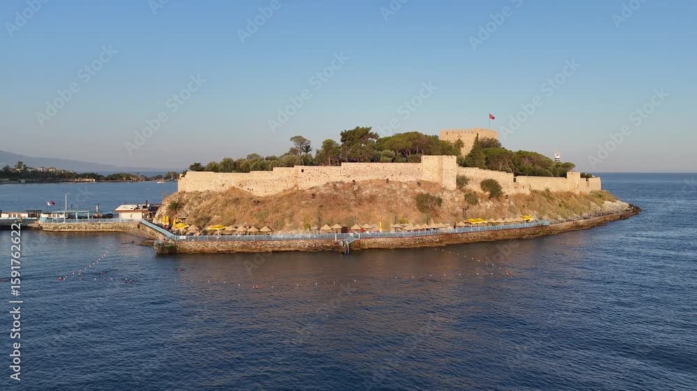 Aerial view of Guvercinada Island (Pigeon Island) with scenic castle at Kusadasi, Turkey. The large resort town is a popular tourist destination in Turkey. Aerial view of Guvercinada Island (Pigeon Island) with scenic castle at Kusadasi, Turkey. The large resort town is a popular tourist destination in Turkey.