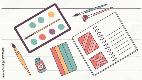 Overhead view of art supplies including a palette, brushes, paint, and a sketchbook on a white table