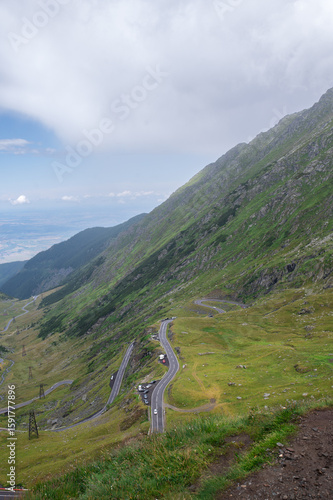 Mountain road with cars in the Fagaras Mountains, Romania. Serpentine section of the Transfagarasan in summer.
