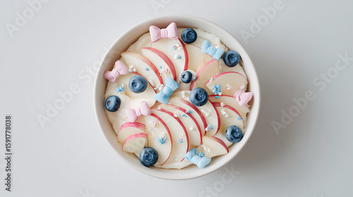 white ceramic bowl filled with neatly sliced red apple and ice cream, close up of a bowl of fruit