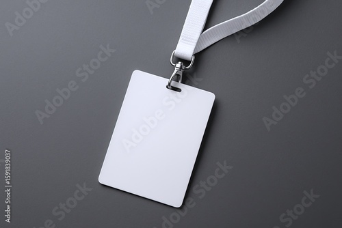 Minimalist blank white identification badge with lanyard on gray background.