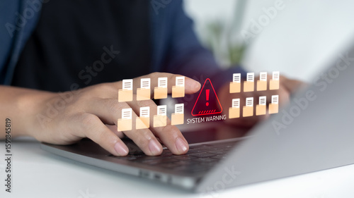 Tablou pe pânză Close-up hands typing laptop with warning alert icon and many file folders, concept of data breach, system error, information leak, cybersecurity protection