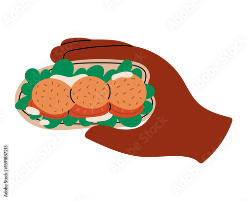 Hand holds Pita bread with falafel