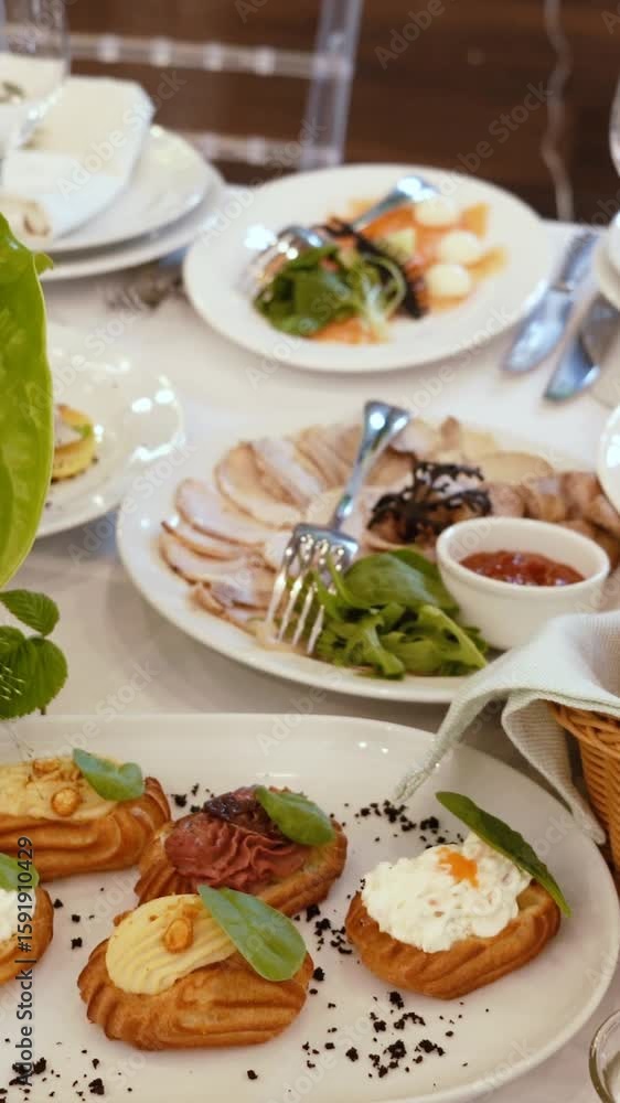 Catering service on banquet table with canape snacks in restaurant or hotel. Decorated food set on birthday, wedding celebration or business conference event venue Catering service on banquet table with canape snacks in restaurant or hotel. Decorated food set on birthday, wedding celebration or business conference event venue