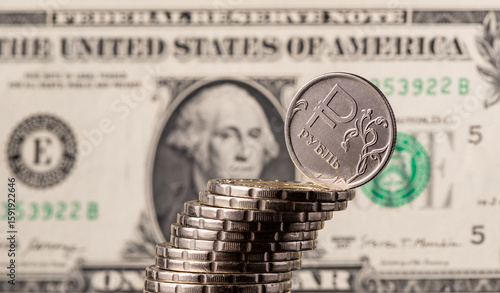 Photography Coin with the symbol of the Russian ruble against the background of a US $1 bill