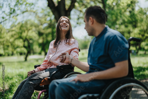 Fototapete Two individuals in wheelchairs spending quality time outdoors in a natural setting, expressing joy and connection