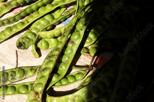 Принти на полотні Petai also known as green stinky beans, being sold fresh and unpeeled at a traditional market