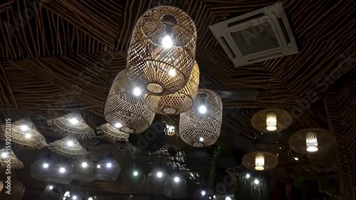 A visual of a restaurant/cafe atmosphere with rattan and bamboo lamps creating warm, natural lighting, adding a touch of rustic aesthetic.