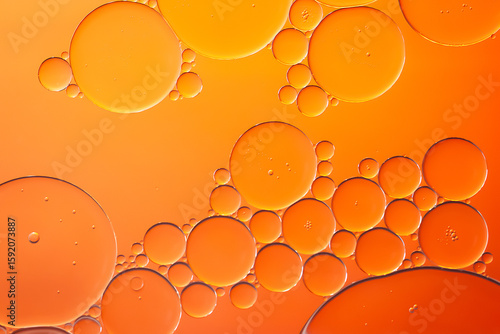 Oil bubbles. Oil bubbles on water in orange tones close-up. Abstract texture
