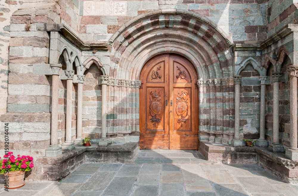 Fototapeta premium Ancient wooden entrance door at the Chapel of Sacra di San Michele, or or St. Michael Abbey, province of Turin, Piedmont, Italy