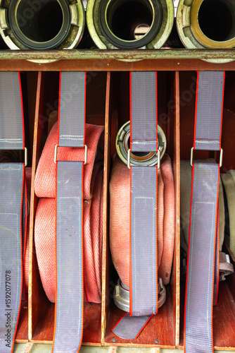 rolled-up fire hoses stored in a historic fire engine