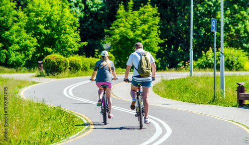 Wallpaper Mural Cyclists ride on the bike path in the city Park
 Torontodigital.ca