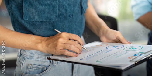 Sustainability and ESG. Professional discussing environmental strategies in a modern office.