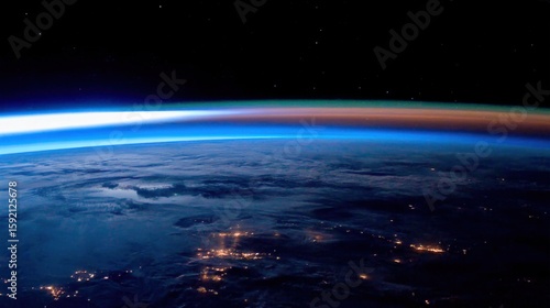 Breathtaking view of Earth from space with textured clouds, urban lights, and a gradient of colors transitioning from blue to orange, stars dotting the black expanse.