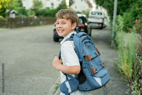 Portrait of a schoolboy with a backpack on the street. Back to school. Studying.