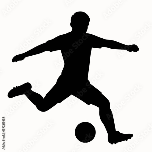 Silhouette of a Soccer Player Kicking a Ball
