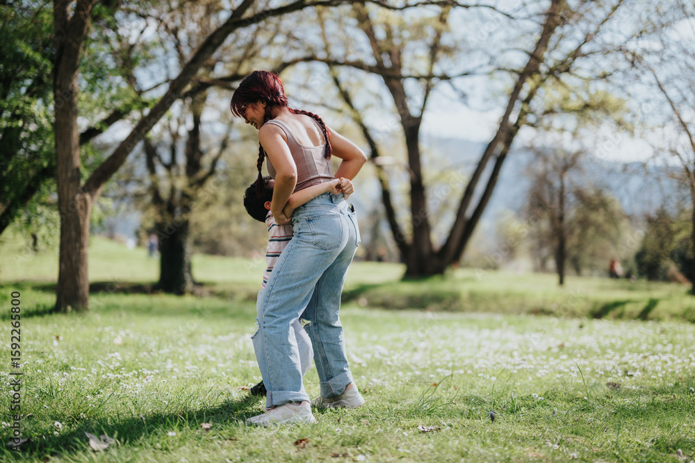 A mother and her child share a joyful moment in a sunlit park, surrounded by greenery and trees, enjoying the serenity of nature and the warmth of family connection. A mother and her child share a joyful moment in a sunlit park, surrounded by greenery and trees, enjoying the serenity of nature and the warmth of family connection.