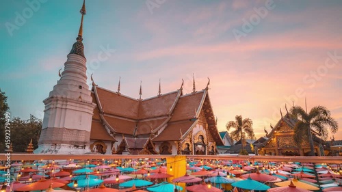 Beautiful buddhist temple in chiang mai at sunset with umbrellas