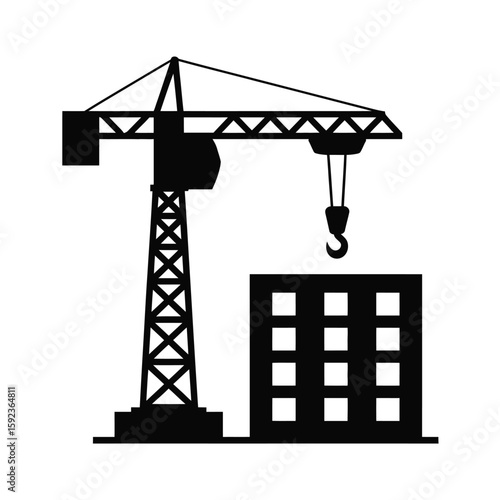 Silhouette of a tower crane lifting materials at a construction site