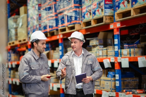 Focused discussion during warehouse operations. Ideal for corporate logistics planning, service strategy, and industry workforce imagery.