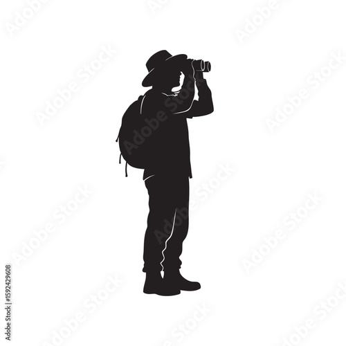 Silhouette of a traveler with binoculars scouting the landscape with backpack
