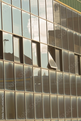 Wallpaper Mural This is a building that features a large number of windows and showcases a beautiful reflection of the sky in its glass facade Torontodigital.ca