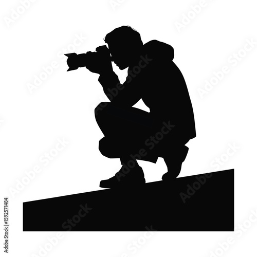 Silhouette illustration of a photographer crouching, black and white vector isolated on white background