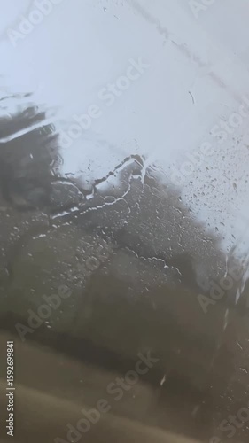 rain on the window in a moving transport. Raindrops on the glass in a train