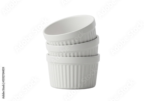 Stacked white ramekins on a plain surface for culinary decoration  