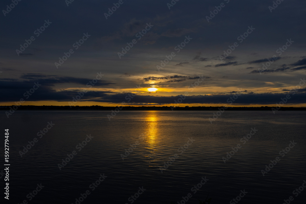 Naklejka premium sunset over the river