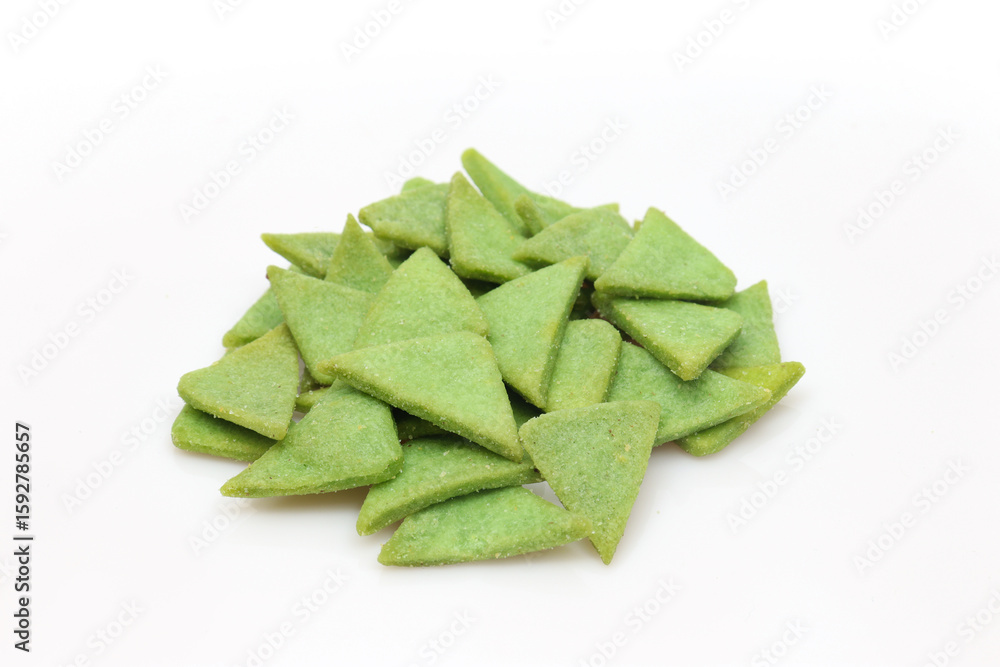 Fototapeta premium Pile of green triangle shaped protein snack isolated on white background