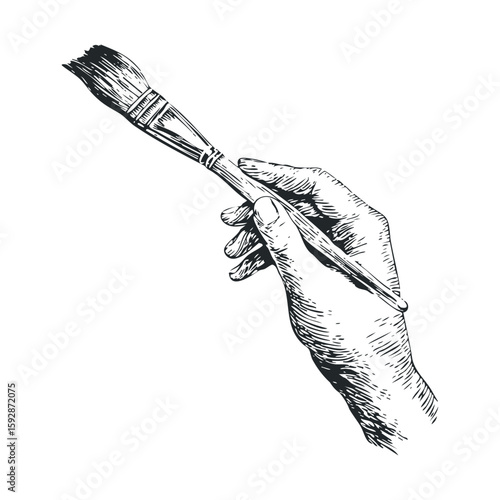 Artistic hand holding paintbrush for creative expression in art
