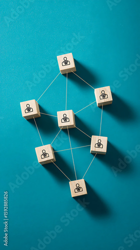 Wooden cubes with people icons connected by threads connection network