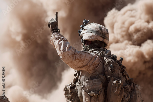 A soldier in a desert with a hand raised in the air