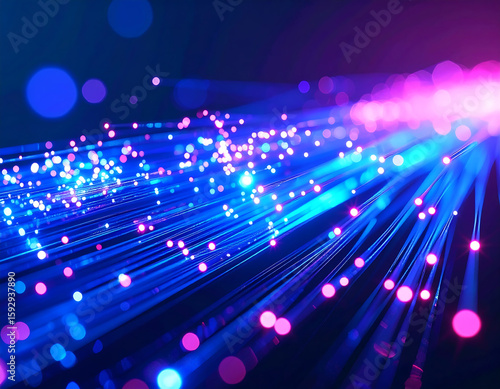 Abstract image of blue fiber optic cables with pink light emitting from the end, creating a bokeh effect.
