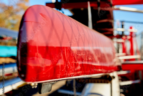 Close up of Red Crew Rowing Boat on Storage Rack