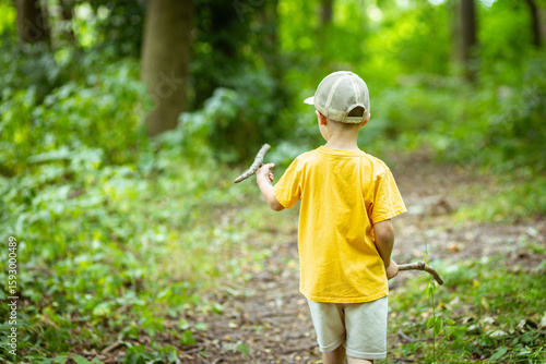 A lonely little boy on a walk in the park
