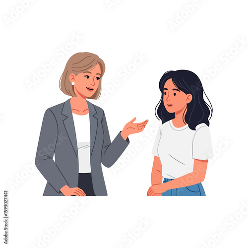 Two women in conversation; one wearing a blazer gestures while speaking to the other in a casual white shirt and jeans.