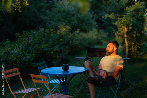 man relaxing in a green garden