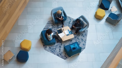 Overhead view of female colleagues discussing in modern office