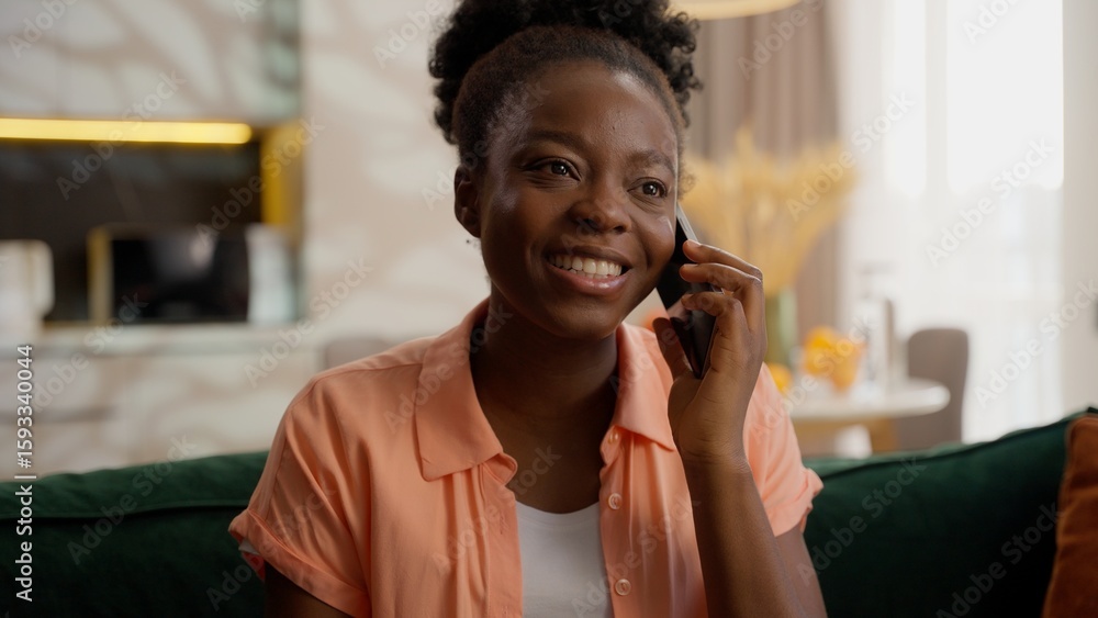 Happy laughing cheerful client African American ethnic business woman female girl lady model portrait businesswoman homeowner talking with friends mobile phone call smartphone speaking gossip at home Happy laughing cheerful client African American ethnic business woman female girl lady model portrait businesswoman homeowner talking with friends mobile phone call smartphone speaking gossip at home