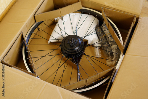 Bike wheel components packed in a cardboard box with protective materials for safe delivery