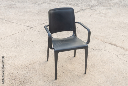 Plastic black chair on the gray background