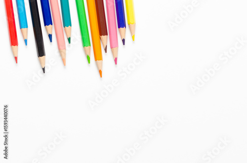 Collection of colorful sharpened pencils on a white background with copy space.