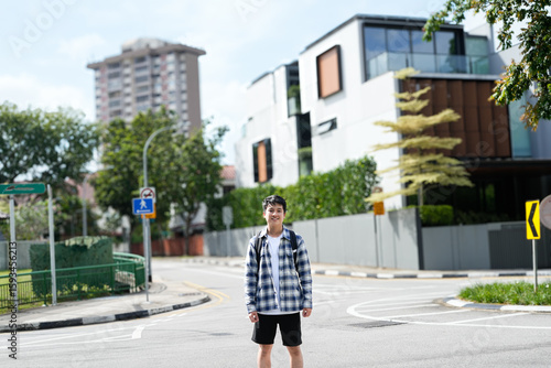 Sticker Man standing at a street pedestrians in a residential area with modern houses an