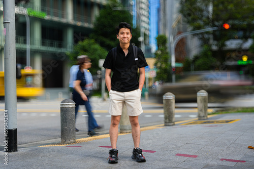 Photography young man standing on a street corner in an urban area
