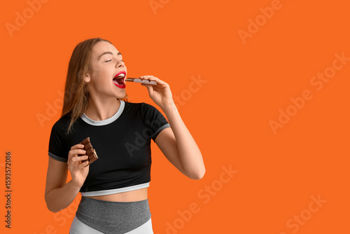Young woman eating chocolat...
