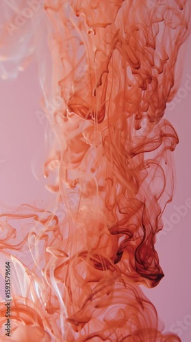 orange ink in water on pink background, slow motion abstract aesthetic art