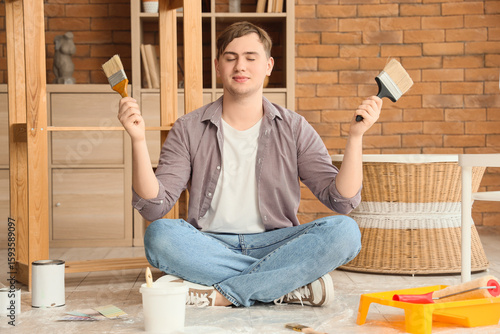 Young man with paint brushe...