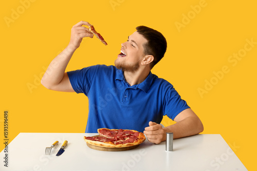 Young man with tasty pepper...